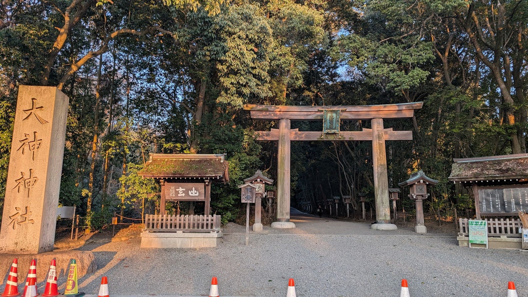 奈良県・大神神社（三輪明神）。夕陽に照らされる石の社標「官幣大社 大神神社」と、参道へと続く二の鳥居の風景。