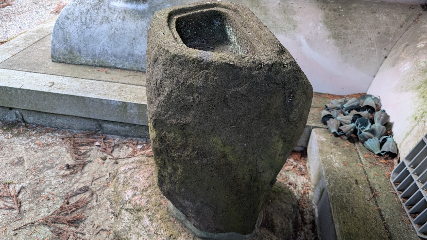 瀧蔵神社の境内の隅に静かに置かれた、苔むした古い石造りの蹲（つくばい）。