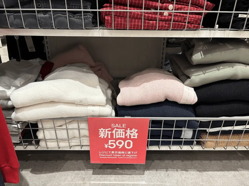 イオンモール橿原のGU店舗で販売されている590円に値下げされたセーターと赤いセールプライスカード。