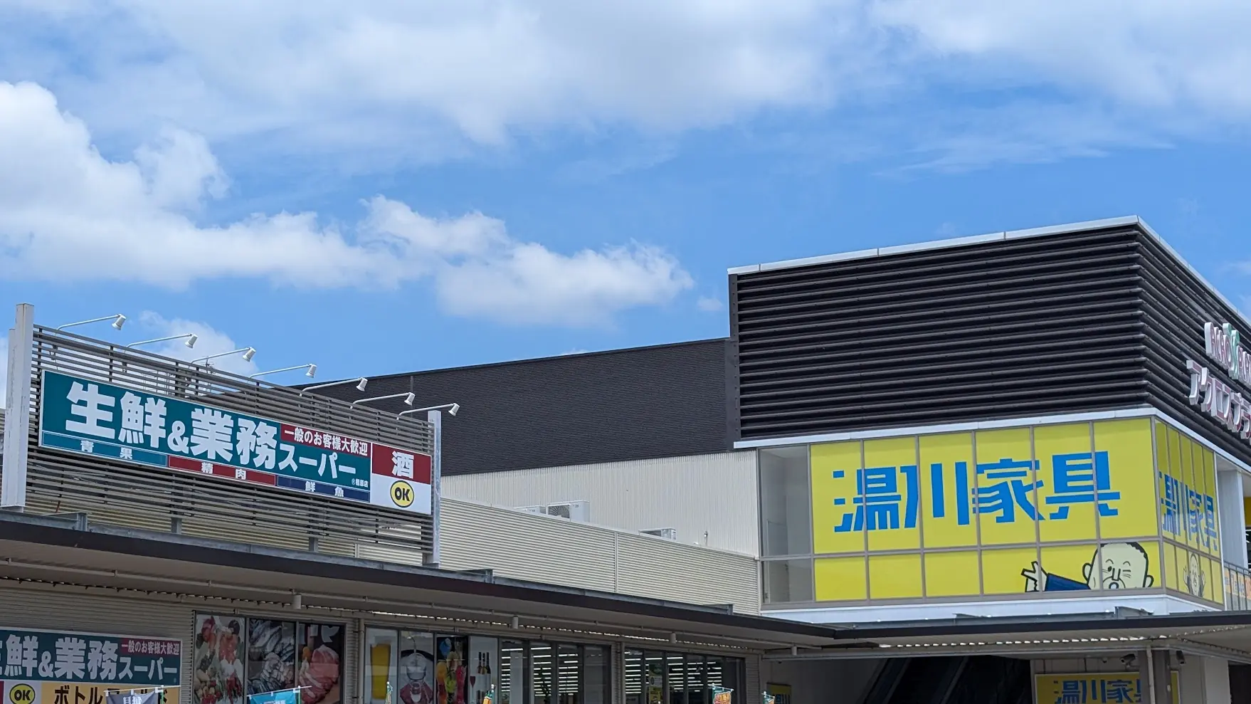 アクロスプラザ橿原内。「湯川家具」と「業務スーパー」の看板が並んでいる様子